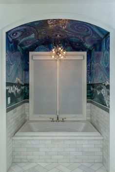 an ornate bathroom with blue and white tiles on the walls