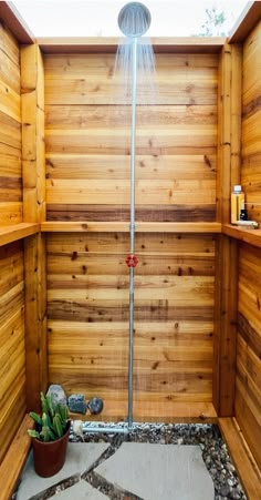 a shower head in the corner of a wooden sauna