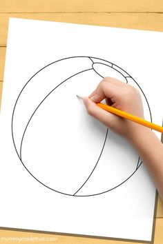 a child's hand holding a pencil and drawing a ball on paper with the shape of an egg