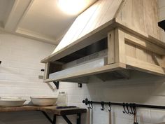 a stove top oven sitting inside of a kitchen next to a wall mounted range hood