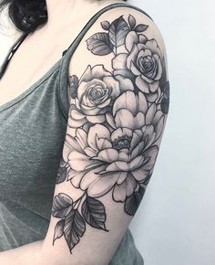 a woman with a flower tattoo on her arm