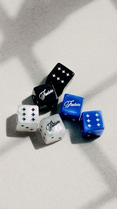 four dices sitting on top of a white surface