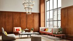 a living room filled with furniture and a chandelier