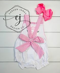 Check out this precious watermelon sunsuit! Perfect for those hot summer days! The Sunsuit is white seersucker with pink seersucker trim. The shoulder straps tie in the back making it adjustable for the perfect fit. Snaps line the bottom for easy diaper changes! A large single initial with a mini watermelon on either side is embroidered directly onto the romper using thread. Fits true to size, please refer to the size chart for sizing questions. Hair bow is not included but is for sale separatel Summer Gingham Cotton Bubble Romper, Pink Summer Bubble Romper For Vacation, White Summer Bubble Romper For Beach, Spring White Bubble Romper For Beach, White Spring Bubble Romper For Beach, Pink Summer Bubble Romper For The Beach, Mini Watermelon, Toddler Boy Easter, Easter Dresses For Toddlers