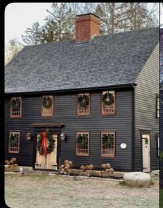 two black houses with wreaths on the windows