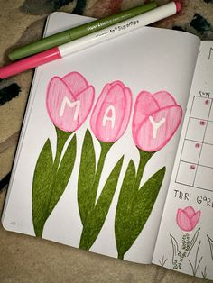 a drawing of pink tulips with the word may written on them