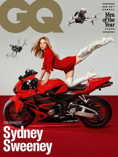 a woman is posing on top of a red motorcycle