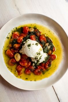 a white bowl filled with food on top of a wooden table