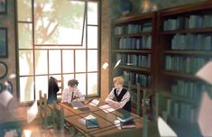 two people sitting at a table in front of bookshelves with open bookcases