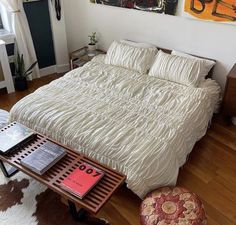 a bed sitting in a bedroom on top of a hard wood floor