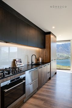 Dark Cabinetry in Queenstown Caravan Kitchen, Kitchen With A View, Kitchen Joinery, Snowy Town, Dark Wood Kitchens, Beach Kitchen, Black Counters, Kitchen Wood