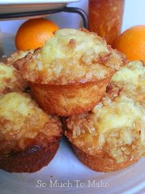 some oranges and muffins are on a plate