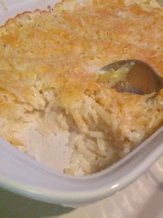 a casserole dish filled with rice and topped with a serving spoon, ready to be eaten