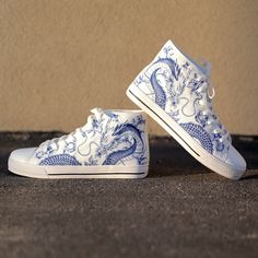 These Blue Dragon Blue Ceramic White high top canvas shoes are ideal for being unique and standing out from the rest of the crowd. To be Gnarly, you need to be different and feel different. These shoes will help you express yourself through the intricate art and gnarly design it displays. This unique shoe is hand drawn/designed in the USA and built with fantastic quality. CONSTRUCTION: Our shoes are very well constructed with quality stitching and a solid base. They are comfortable and durable and suitable for most occasions. HANDCRAFTED DESIGN: Wearing these shoes is making a statement. Our shoes have bold and gnarly designs that fit anyone who want to separate themselves from the rest. The designs are inspired by art and beauty from around the world. Exclusively designed in the USA. __FE Sneakers Custom Ideas, White Converse Custom Ideas, Custom Shoe Design Ideas, Dragon Converse, Sneaker Customization, Custom Shoes Design, Shoe Painting Ideas, Blue And White Shoes, Unique Converse