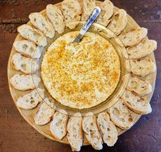 a glass plate with bread on it and a spoon in the bowl next to it