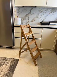 a ladder leaning against the wall in a kitchen