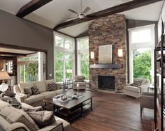 a living room filled with furniture and a fire place in the middle of a room