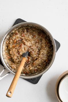 a pot with food and a wooden spoon