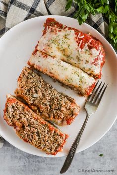 slices of meatloaf on a plate with a fork and parmesan cheese