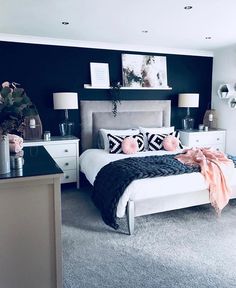 a black and white bedroom with pink accents