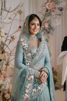 a woman in a blue wedding dress and veil