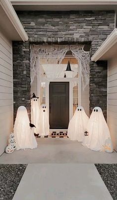 halloween decorations are on display in front of a home's entryway, decorated for the holiday season