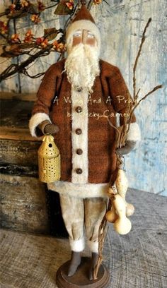 a santa claus figurine is holding a lantern and some mushrooms in his hand