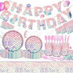 a mermaid birthday party with pink and blue decorations, plates, cups, and cake