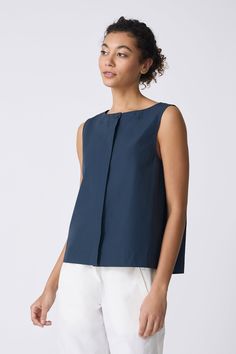 Sweet and simple, our Colette Shell is the perfect Spring into Summer top. With a boatneck shape, this charming top will soon be your bestie. Boat neck style with stitch down facing, center front hidden placket with top button exposed, back inverted pleat with stitch detail, wide finish hem - 51% Cotton, 49% Nylon - Fabric woven in Italy - Made in NYC - Dry clean or machine wash - Our model is 5'9" wearing size S - Chest 39", Hip 42", Length 23" Orders are processed within three business days (n Spring Sleeveless Top With Button Back, Sleeveless Spring Top With Button Back, Sleeveless Button Back Top For Spring, Sleeveless Tops With Button Back For Spring, Chic Sleeveless Top With Back Button Closure, Spring Sleeveless Tops With Back Button Closure, Sleeveless Tops With Back Button Closure For Spring, Sleeveless Tops For Work With Back Button Closure, Sleeveless Workwear Top With Back Button Closure