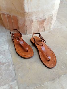 A beautiful 100% handcrafted women's sandal made with real leather and high quality organic material, perfect for sunny days, it is very comfortable and elegant. Soft and light, it is entirely handmade All manufacturing stages are carried out by hand All sizes are available Brown color ALL ORDERS ARE NOW SHIPPED VIA ARAMEX EXPRESS WORLDWIDE (please include a phone number at checkout, as it is required by the carrier). If you are unsure of your size, please contact me so I can help you. Wholesale T-strap Sandals With Rubber Sole For Vacation, Vacation T-strap Sandals With Rubber Sole, Summer Sandals With Leather Sole And Single Toe Strap, Summer T-strap Sandals With Leather Sole, Summer Vacation T-strap Sandals With Leather Sole, Leather Toe Ring Sandals For Summer, Summer Toe Loop Barefoot Sandals With Leather Footbed, Leather T-strap Barefoot Sandals For Beach, Leather Huarache Sandals With Leather Lining For Summer