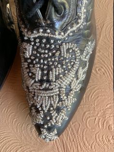 Here is an absolutely gorgeous pair of beaded black Victorian leather boots made by Marshall Fields & Co. Chicago. The toe box is adorned with rich, glittering glass beading that wraps around the sides. They show very little wear as if they were only worn once. As with most Victorian boots, they are quite small and very narrow: Toe to heel measure = 9 inches; ball of foot = 2 1/2 inches. It is certainly rare to find a pair of boots from this era in such magnificent shape. Designer Embellished Evening Boots, Elegant Wedding Boots Embellished, Elegant Embellished Wedding Boots, Designer Rhinestone Boots For Formal Events, Designer Rhinestone Boots For Formal Occasions, Designer Rhinestone Formal Boots, Elegant Bedazzled Evening Boots, Elegant Evening Bedazzled Boots, Elegant Leather Boots With Bling