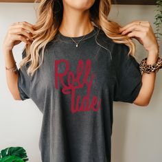 a woman wearing a t - shirt with the word self tide printed in red on it