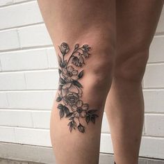 a woman's leg with flowers on it