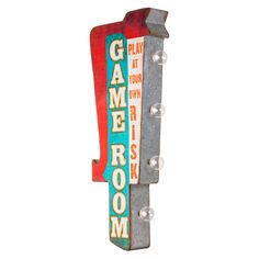 a metal sign that says game room on it's side and is hanging from the wall