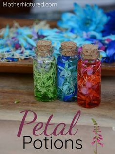 three bottles filled with different colored confetti sitting on top of a wooden table