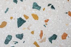 the floor is made up of different colored pieces of glass and pebbles, which are scattered on top of each other