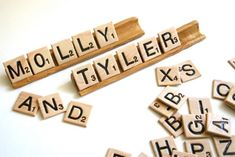 scrabble letters spelling out the word mollilly and tyllers on a white surface