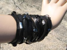 "Bohemian Jewelry By Vacationhouse, Wide Black Leather Cuff Bracelet, Sliced Silver Beaded Fringe Wrist Wrap. Custom made to order. VACATIONHOUSE Fine Quality Hats, Beanies, Leather Jewelry, Leather Hair Wraps & Accessories. Luxury Fibers & Italian Leathers www.Vacationhouse.etsy.com ..Super wide Leather Statement Cuff Bracelet 1 Leather sliced Bracelet Black Leather with silver and glass beads Elegant with the right amount of Rocker. 4 snap closure 4\" Tall You chose wrist size length ( Handmade Bohemian Black Wrap Bracelet, Bohemian Black Handmade Wrap Bracelet, Black Beaded Bohemian Leather Bracelet, Bohemian Black Cuff Bracelet, Black Bohemian Bracelet, Black Bohemian Wrap Bracelet For Festival, Bohemian Black Wrap Bracelet For Festival, Black Hand Wrapped Wrap Bracelet For Festival, Black Leather Cuff Bracelet