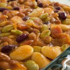 a casserole dish with beans and other foods in it sitting on a table