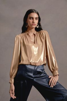 This split-neck blouse has a decadent feel thanks to its lustrous metallic sheen. It has gentle gathers and puffed long sleeves finished by button cuffs. •Split neckline •Long sleeves •Button cuffs •Bubble hem Item number 2330079 100% Polyester Shiny Party Blouse For Fall, Metallic Sheen Tops For Fall, Glamorous Fall Blouse With Blouson Sleeves, Chic Long Sleeve Puff Sleeve Top For Party, Fall Evening Blouse With Shimmer, Glamorous Blouse With Blouson Sleeves For Fall, Fall Party Blouse With Bishop Sleeves, Chic Shiny Tops For Fall, Night Out Blouse With Blouson Lantern Sleeves