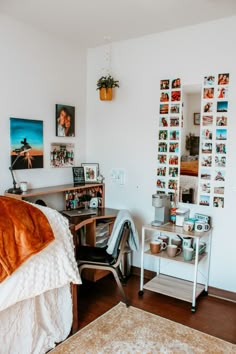 a bedroom with a bed, desk and pictures on the wall