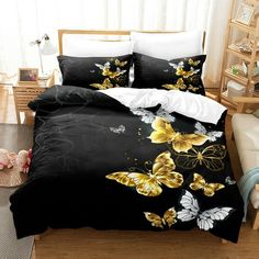 a bed covered in black and yellow butterflies