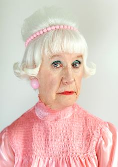 an older woman with white hair and pink dress