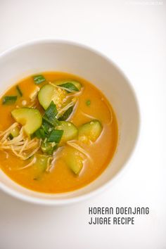 a white bowl filled with soup on top of a table