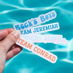 someone holding up some stickers in front of a pool that says, beck's boys team jeremah