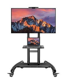 a flat screen tv sitting on top of a black stand next to a computer monitor