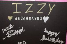 a black board with writing on it that says izzay autographs and happy birthday