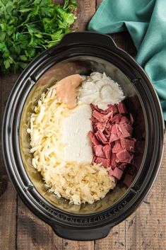 the ingredients for this slow cooker meal include meat, cheese and gravy