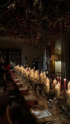 a long table with many lit candles on it