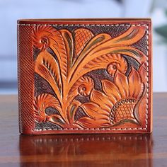 a leather wallet sitting on top of a wooden table